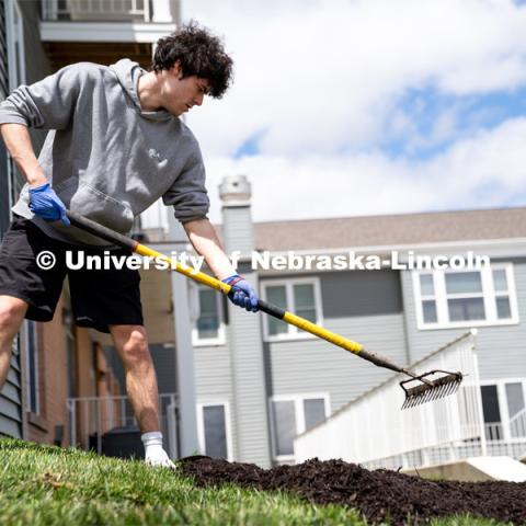 Pi Kappa Alpha’s Grant Breidenbach spreads out mulch at the Van Dorn Villa Retirement Living complex during the Big Event. May 4, 2024. Photo by Kirk Rangel for University Communication.